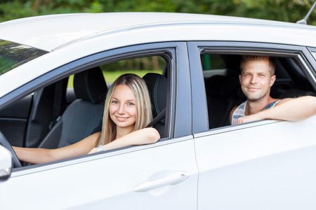 Young happy people enjoying a roadtrip in the carの写真素材