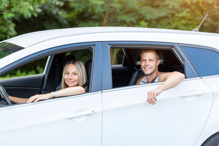 Young happy people enjoying a roadtrip in the carの写真素材