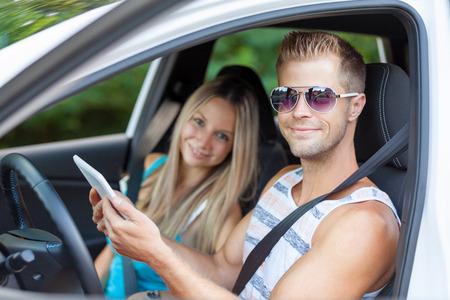 Young happy people enjoying a roadtrip in the carの写真素材