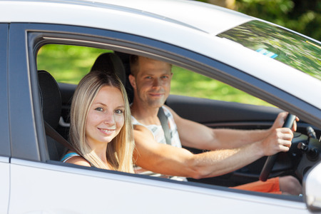 Young happy people enjoying a roadtrip in the carの写真素材