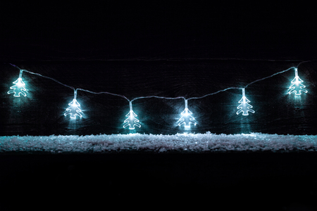 Traditional Christmas decoration lights with snow and copy spaceの写真素材