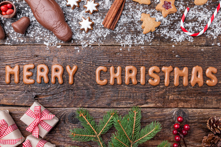 Festive Christmas wooden background with sweets and decoration