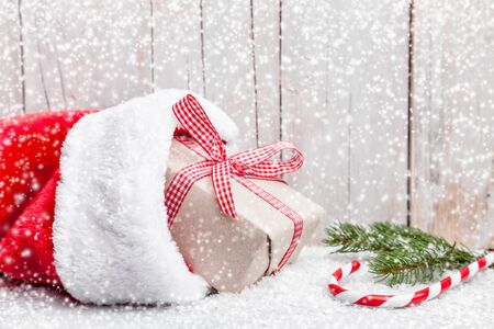 Christmas presents with snow on grey wooden backgroundの写真素材