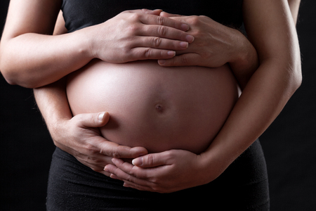 Portrait of young and delighted parents expecting a babyの写真素材