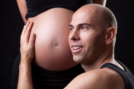 Portrait of young and delighted father expecting a babyの写真素材