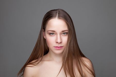 Beautiful young brunette woman with long hairの写真素材