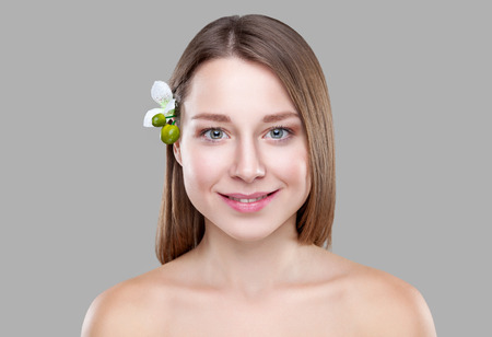Beautiful brunette woman with a white flower in hairの写真素材
