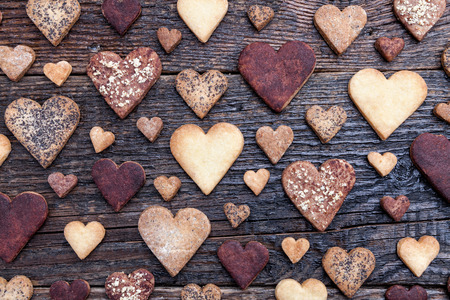 Delicious heart shaped cookies baked with love on wooden backgroundの写真素材