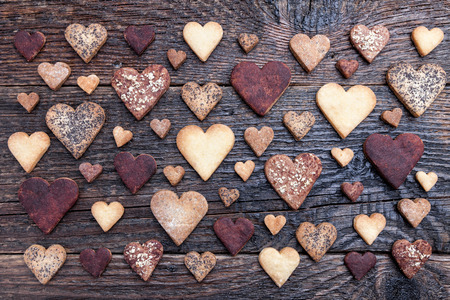Delicious heart shaped cookies baked with love on wooden backgroundの写真素材