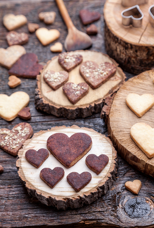 Delicious heart shaped cookies baked with love on wooden backgroundの写真素材