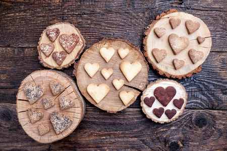 Delicious heart shaped cookies baked with love on wooden backgroundの写真素材