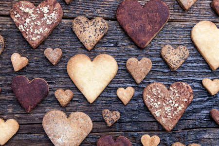 Delicious heart shaped cookies baked with love on wooden backgroundの写真素材