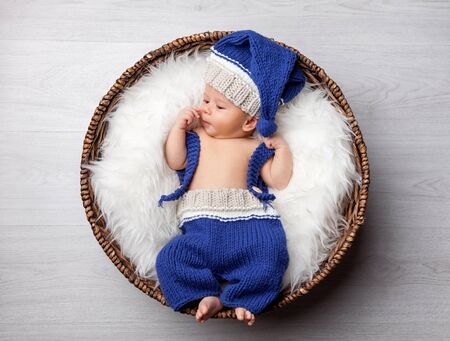 Beautiful newborn inside a wicker basketの写真素材