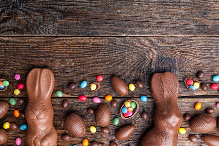 Delicious chocolate Easter bunny and eggs on wooden backgroundの写真素材
