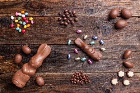 Delicious chocolate Easter bunny and eggs on wooden backgroundの写真素材
