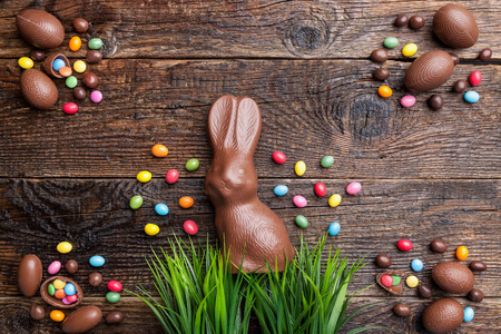 Delicious chocolate Easter bunny and eggs on wooden backgroundの写真素材