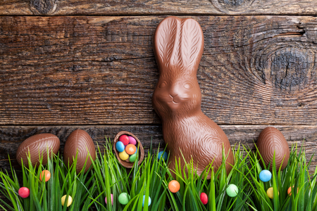 Delicious chocolate Easter bunny and eggs on wooden backgroundの写真素材