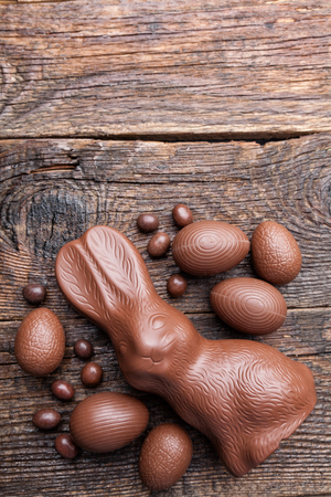 Delicious chocolate Easter bunny and eggs on wooden backgroundの写真素材
