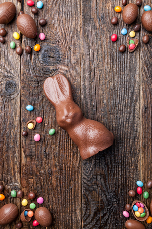 Delicious chocolate Easter bunny and eggs on wooden backgroundの写真素材