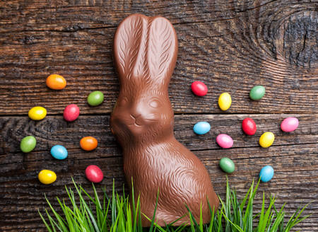 Delicious chocolate Easter bunny and eggs on wooden backgroundの写真素材