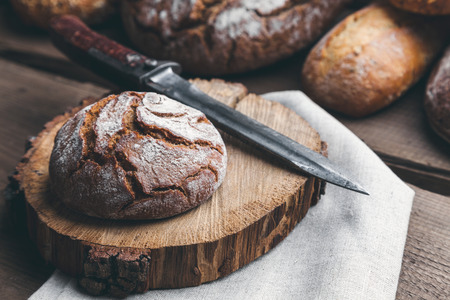 Delicious freshly baked bread on wooden backgroundの写真素材