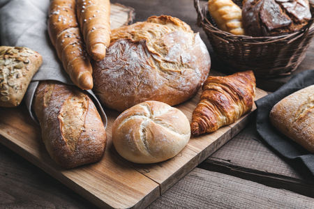 Delicious freshly baked bread on wooden backgroundの写真素材