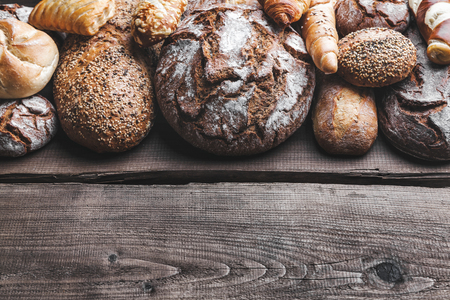 Delicious freshly baked bread on wooden backgroundの写真素材