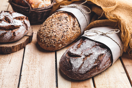 Delicious freshly baked bread on wooden backgroundの写真素材