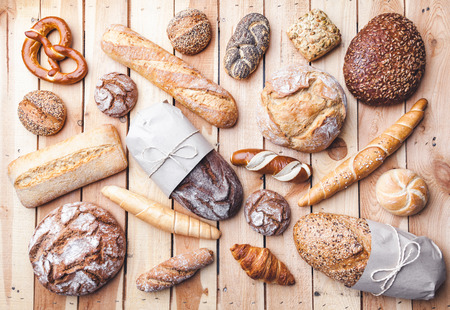 Delicious freshly baked bread on wooden backgroundの写真素材