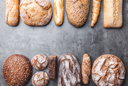 Delicious freshly baked bread on wooden backgroundの写真素材