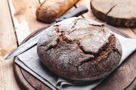 Delicious freshly baked bread on wooden backgroundの写真素材