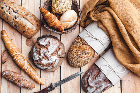 Delicious freshly baked bread on wooden backgroundの写真素材