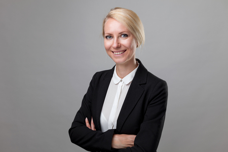 Young and happy business woman in suitの写真素材