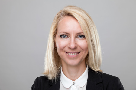 Closeup headshot of young and happy business womanの写真素材