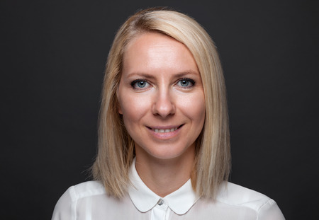 Closeup headshot of young and happy business womanの写真素材