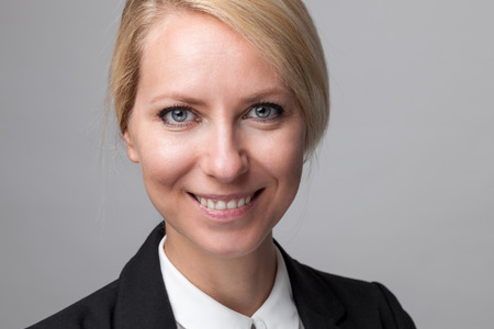 Closeup headshot of young and happy business womanの写真素材