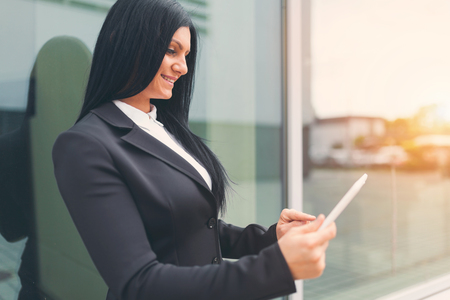 Young successful business woman working with tablet in an urban settingの写真素材