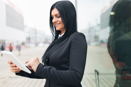 Young successful business woman working with tablet in an urban settingの写真素材