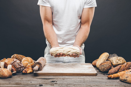 Baker with a variety of healthy and delicious freshly baked bread and pastry