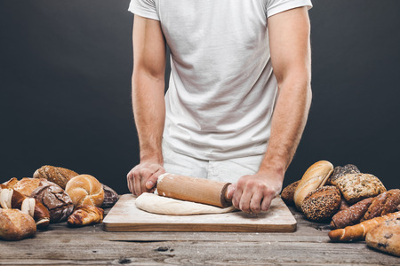 Baker with a variety of healthy and delicious freshly baked bread and pastryの写真素材