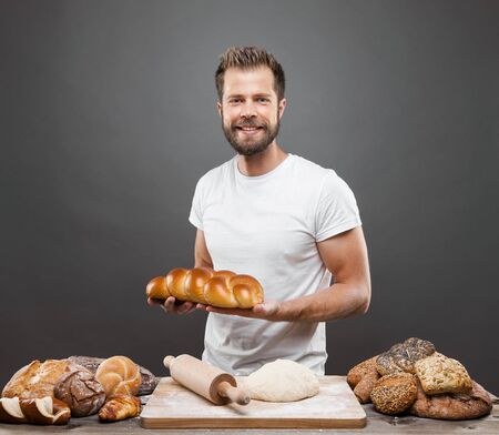 Baker with a variety of healthy and delicious freshly baked bread and pastryの写真素材