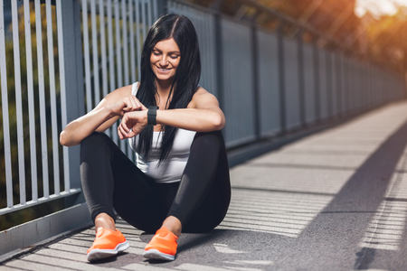 City workout. Beautiful young woman with a smartwatch training in an urban settingの写真素材
