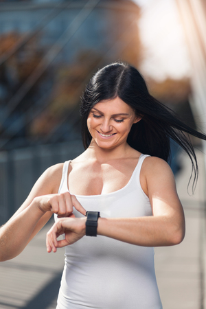 City workout. Beautiful young woman with a smartwatch training in an urban settingの写真素材