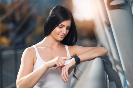 City workout. Beautiful young woman with a smartwatch training in an urban settingの写真素材