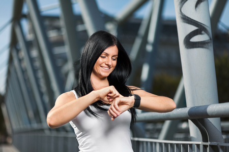 City workout. Beautiful young woman with a smartwatch training in an urban settingの写真素材