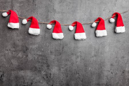 Traditional Christmas Santa hats on rustic background with copy spaceの写真素材