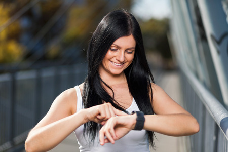 City workout. Beautiful young woman with a smartwatch training in an urban settingの写真素材