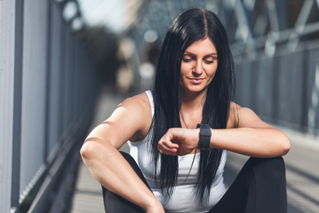 City workout. Beautiful young woman with a smartwatch training in an urban settingの写真素材