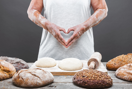 Baker preparing a variety delicious fresh bread and pastryの写真素材