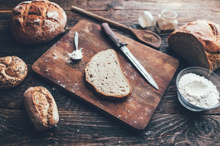 Delicious freshly baked bread on wooden backgroundの写真素材